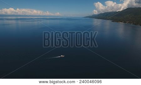 Aerial View Of Motor Boat In Sea. Aerial Image Of Motorboat Floating In A Turquoise Blue Sea Water. 