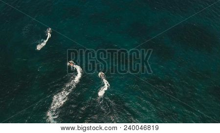 People Riding On A Jet Ski. Aerial View Man Driving A Jet-ski At Sea.jet Ski On The Water Of The Sea