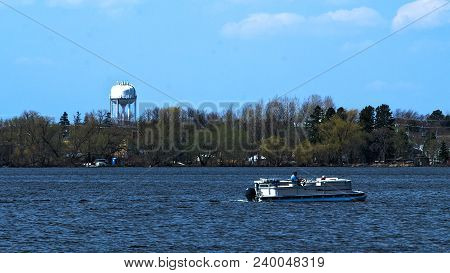 Pontoon On Lake Irving In Northern Minnesota On Sunny Day With Bemidji In Background