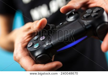 Male hands holding a PS4 controller