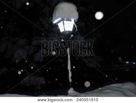 Snow Covered 60s Style Street Lamp Post During A Winter Storm