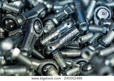 Close-up Glossy Steel Bolts Background. Brand New Stainless Screws Or Fastener. Industrail Abstract 