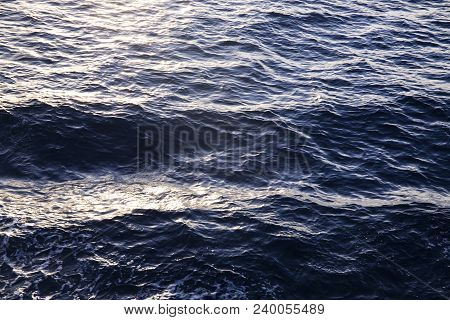 Sea Water Texture In Sunrise Light. Water Background Texture. Sea Surface In Sunset Light. Breezy Wa