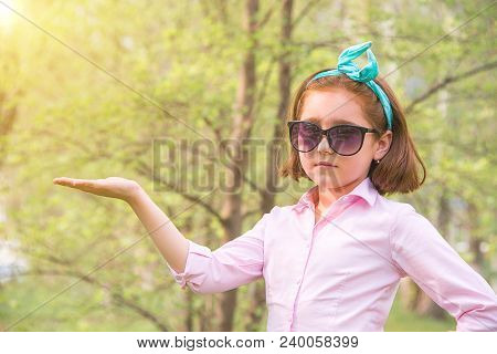 Girl In A Pink Shirt And Sunglasses In The Nature, Smiling And Cheering Emotionally