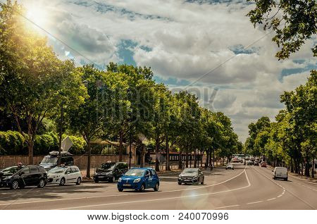Paris, France - July 11, 2017. Cars On A Tree-lined Street In Sunny Day At Paris. Known As The 