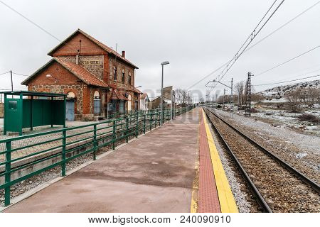 Otero De Herreros, Spain - March 31, 2018: Old Train Station Against Snowcapped Mountains