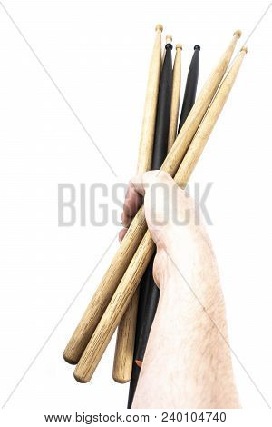 A Lot Of Drumsticks Of Two Colors In A Hand, Isolated On A White Background