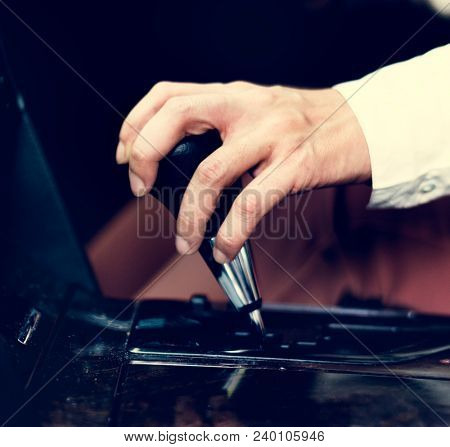 Woman holding on to a gearstick