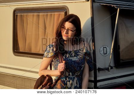 Beautiful Young Caucsian Girl Posing On Front Of A Camper Van On A Sunset. Spirit Of Freedom And You