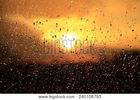 Rain Outside Window On Background Of Sunset. Rain Drops On Glass During Rain. Sunset Outside Window 