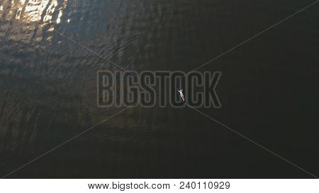 Young Girl Floats On An Inflatable Mattress In The Lake.aerial View:girl Is Happy And Float On Infla