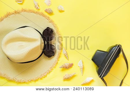 Straw Beach Foman's Hat, Black Sun Glasses With Retro Camera On Yellow Background. Top View. Flat La
