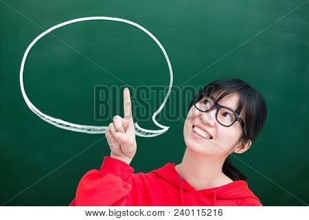 Woman Student Pointing And Look Somewhere With Speech Bubble On Green Chalkboard