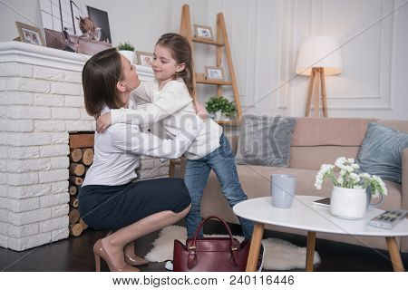 Goodbying. Lovely Cheerful Girl Smiling And Hugging Her Mom