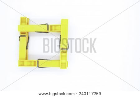 Four Yellow Pegs On White Background - Square From Top
