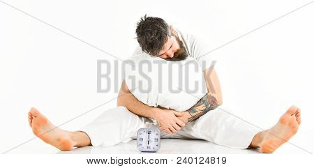 Man With Tattoo Fall Asleep While Sitting, White Background. Morning Alarm Concept. Hipster With Bea