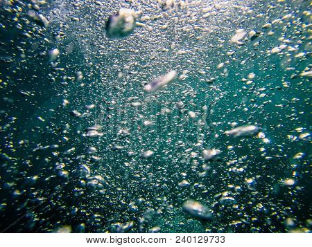 Air boobles in blue sea water. Maldives.