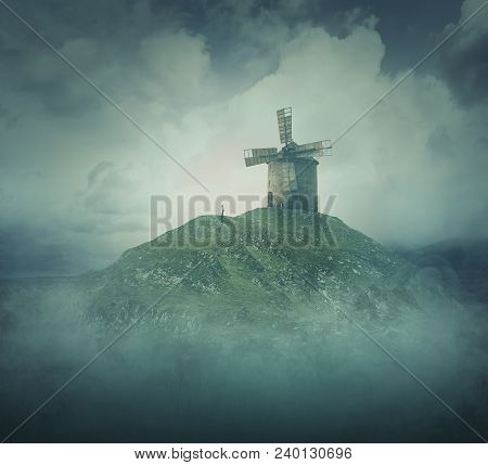 Scenery View As A Wander Girl Silhouette Stand In Front Of An Old Windmill On The Top Of A Hill Surr