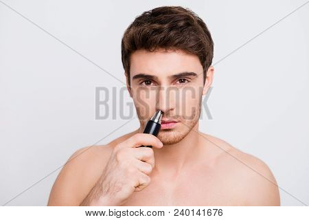 Close Up Portrait Of Handsome Confident Concentrated With Bristle Stubble Man Using Electric Machine