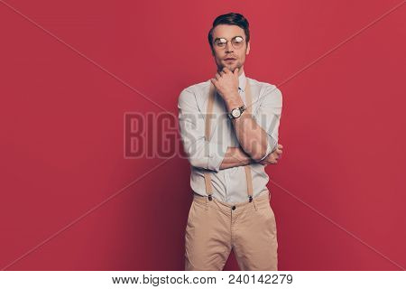 Portrait Of Haughty Brunet Virile, Harsh Arrogant Man With Modern Hairstyle Touching Chin With Finge