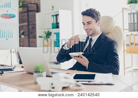 Half-turned Portrait Of Cheerful Excited Carefree Delightful Handsome Attractive Smart Employee Sitt