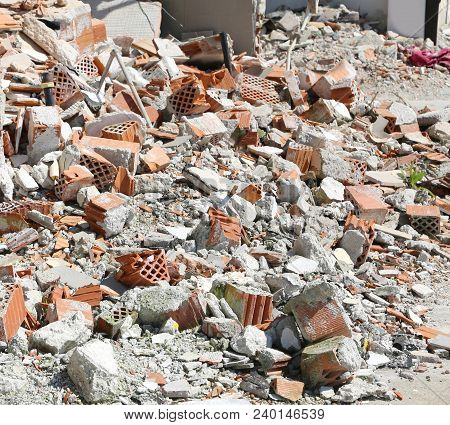 Many Demaged Houses With Broken Bricks Wall And Debris