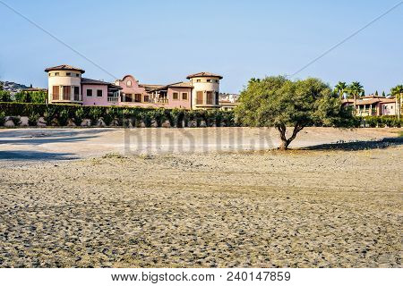 Daylight View To Buildings Near Beach With Car Tires Traces