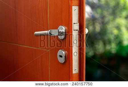 Open Door Of A Family Home. Close-up Of The Lock An Armored Door.