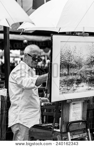 Paris, France - July 06, 2017: The Painter Works At The Open Air Artist Market At The Tertre Square 