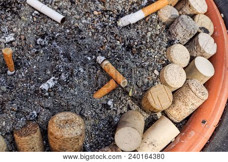 Many Cigarette Butts In The Dirty Ashtray. A Lot Of Cigarette Butts. Reason Of Lung Cancer. Lots Of 