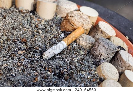Many Cigarette Butts In The Dirty Ashtray. A Lot Of Cigarette Butts. Reason Of Lung Cancer. Lots Of 