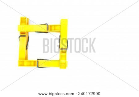 Four Yellow Pegs On White Background - Square From Top