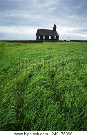 Black wooden church Budakirkja. Famous tourist attractions of Iceland near the village Budhir