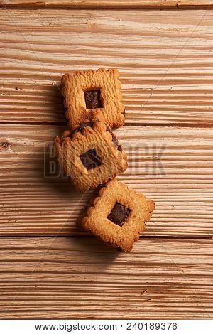 Stacked Chocolate Chip Cookies On A Light Wooden Background
