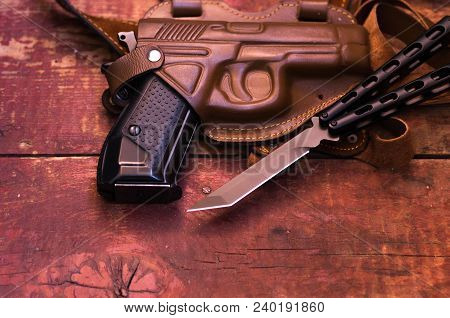 A Knife And A Gun. A Pistol In A Leather Holster.