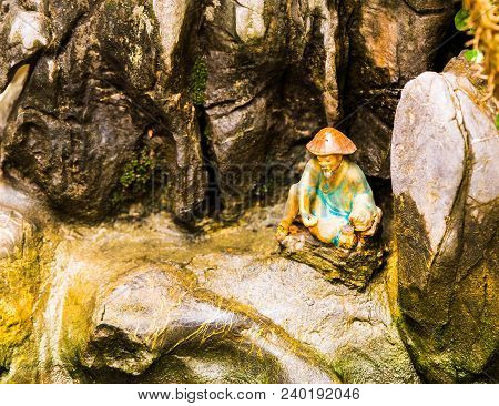 Small Figurine In The Garden In Hanoi, Vietnam. Close-up.