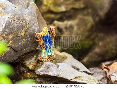 Small Figurine In The Garden In Hanoi, Vietnam. Close-up.