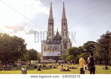 Vienna Austria May 3. 2018, Votivkirche Is The Second Largest Church In Vienna, People Sitting On Gr