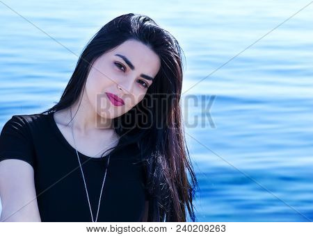 Happy Woman On The Beach. Portrait Of A Beautiful Girl Close-up. Spring Portrait On The Beach. Young