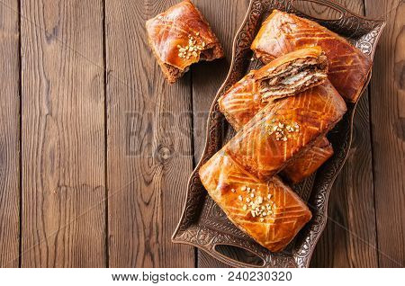 Traditional Turkish Pastry Roll With Chocolate And Nuts Filling - Pastich Served On A Vintage Tray.