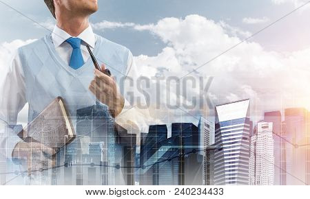Double Exposure Of Confident And Young Businessman In Smart-casual Wear Smoking Pipe And Modern City