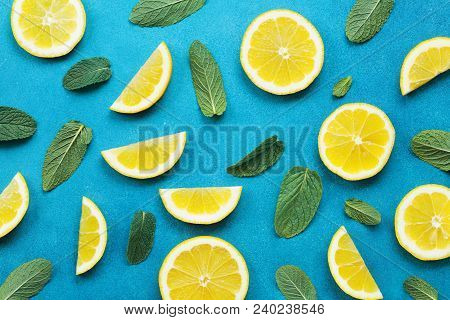 Punchy Pastel Background With Lemon Slices And Mint Leaves. Summer Colorful Pattern. Flat Lay Style.