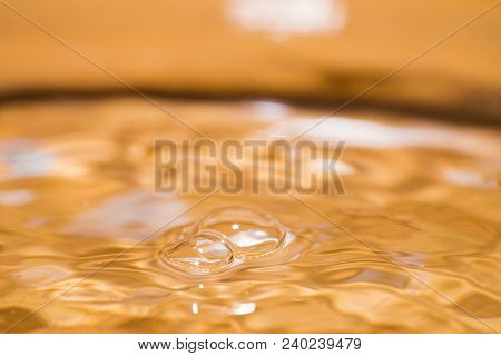 Shining Bubbles On Water Surface Colored Of Orange Isolated Composition
