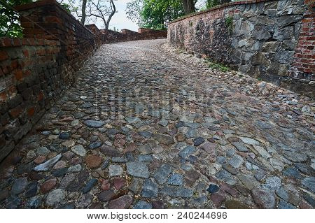 A Cobbled Road To The Medieval Castle In Otmochów In Poland
