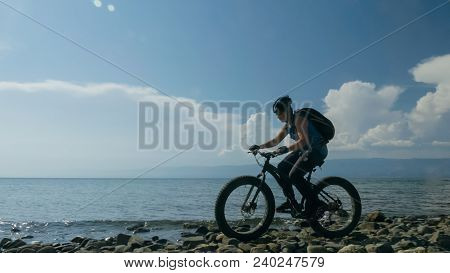 Fat Bike Also Called Fatbike Or Fat-tire Bike In Summer Driving On The Beach. The Guy Is Going Strai