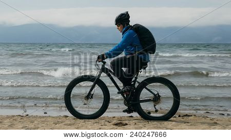 Fat Bike Also Called Fatbike Or Fat-tire Bike In Summer Driving On The Beach. The Guy Is Going Strai