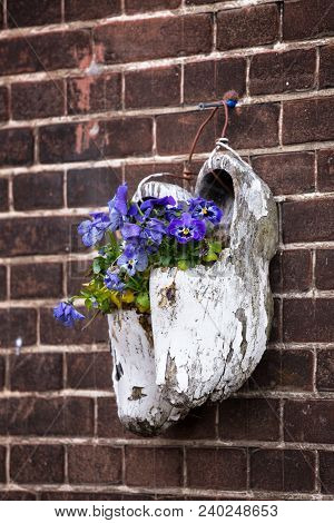 Wooden Klompen On Brick Wall Background
