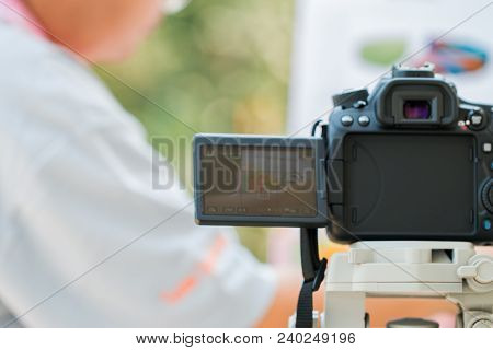Blurred Of Photographers Using Camera Located On Tripod To Take Pictures Of Online Shopping For Sale