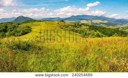 Autumnal Countryside Of Carpathian Mountains. Grassy Meadow And Magnificent Pikui Peak Of Carpathian