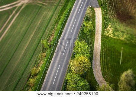 Highway Asphalt Road Seen From Above With Trees And Meadows Along The Roadside
